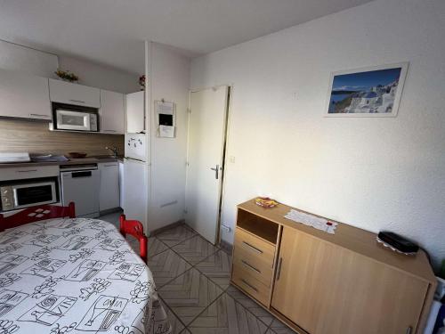 Cette petite chambre dispose d'une cuisine avec un lit. dans l'établissement Appartement Climatisé, Calme, Proche Centre Port et Plage pour 4 Personnes - FR-1-607-14, au Cap d'Agde