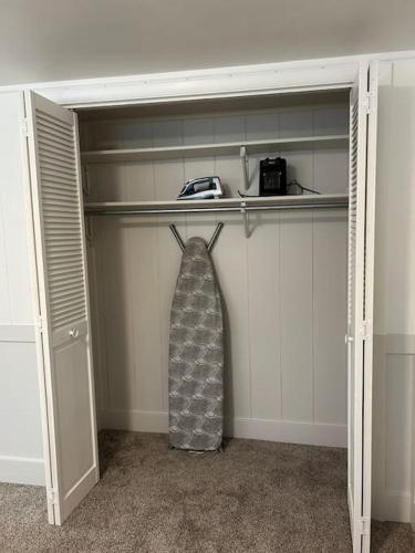 a closet with a robe hanging on the door at Cozy Mountain Retreat in Morgan