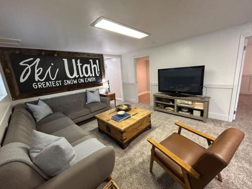 a living room with a couch and a flat screen tv at Cozy Mountain Retreat in Morgan