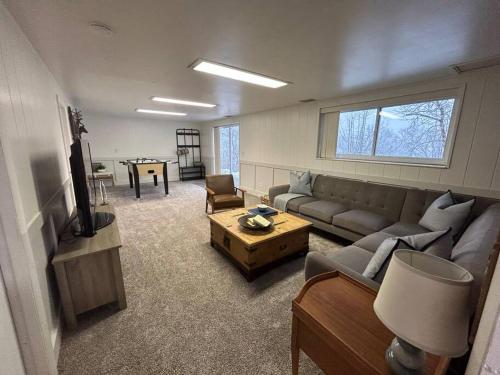a living room with a couch and a table at Cozy Mountain Retreat in Morgan