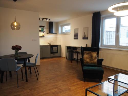 a living room with a table and chairs at Apartmány Abacie in Nový Jičín