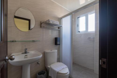 een badkamer met een wastafel, een toilet en een spiegel bij 木子寓所 Moozhouse in Magong