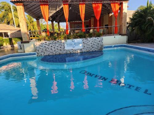 odivin hotel luxury suite في Gonaïves: مسبح في منتجع فيه ماء ازرق