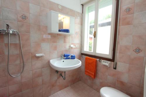 ein Bad mit einem Waschbecken und einer Dusche in der Unterkunft Dolomiti in Bibione