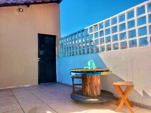 a table sitting on a patio next to a building at Kitnet Towers in Praia Grande