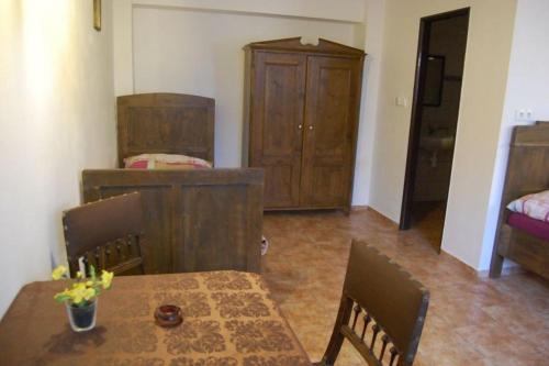 a room with a table and chairs and a bedroom at Pension Na Staré Poště in Přelouč