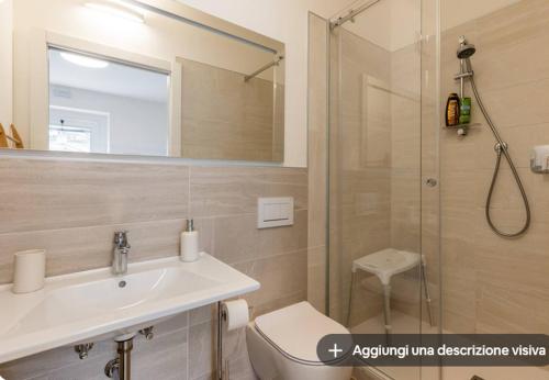 a bathroom with a toilet and a sink and a shower at Vittoria room in Bardolino