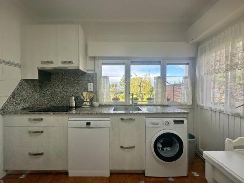 a kitchen with a washing machine and a washer at Chalet Pitu - 17801 in Piedrahita