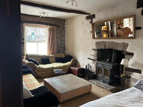 a living room with a couch and a fireplace at Half Moon House in Hay-on-Wye