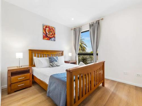 a bedroom with a bed and a window at Wonderful Three Bedroom with Garage in Auckland