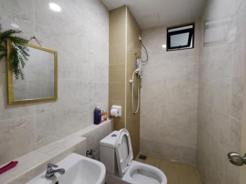 a bathroom with a sink and a toilet and a mirror at DSummit 3bedroom WiFi Netflix 5 Pax in Johor Bahru