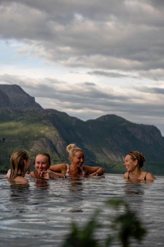 a group of women swimming in a body of water at Skarsnuten Mountain Resort & SPA in Hemsedal