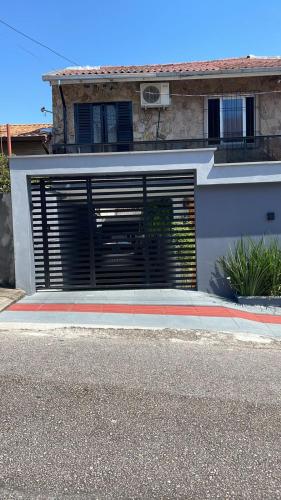 a building with a garage door with a window at Espaço da Zilda in São José