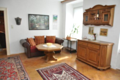 a living room with a couch and a table at Haus Weisses Lamm in Weitensfeld