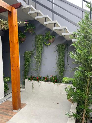 a stairway with plants and flowers on a wall at Espaço da Zilda in São José