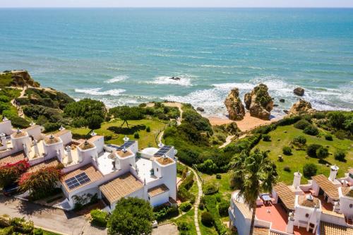 an aerial view of a house and the ocean at 3-Bed Clifftop Beach House - Pool, Private Garden, Rooftop & Paddle Boards in Porches