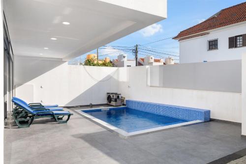 a swimming pool on the roof of a house at Charmy Villa Estoril by Amber Star Rent in Cascais