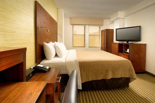 a hotel room with a bed and a flat screen tv at Comfort Inn Downtown DC-Convention Center in Washington
