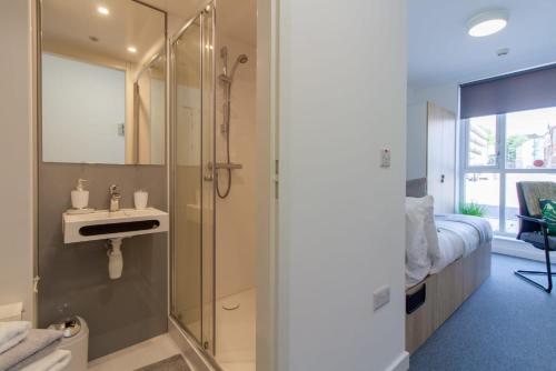 a bathroom with a shower and a sink at Exquisite Ensuites at The Croft Derby in Derby