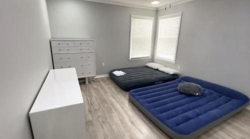 a bedroom with a large blue bed in a room at Kildrummy Lux Apartment in Davenport