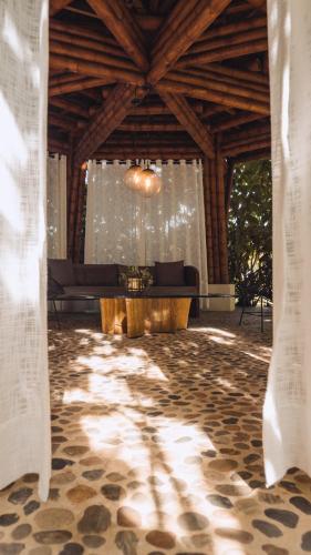a living room with a couch and a table at El Rio Hotel in Doradal