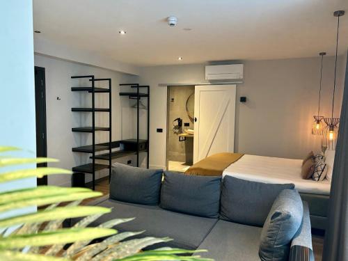a bedroom with a bed and a couch in a room at Hotel La Boutique in Nijmegen