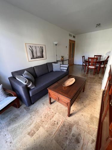 a living room with a couch and a coffee table at Jerez, zona norte, Cadiz, España in Jerez de la Frontera