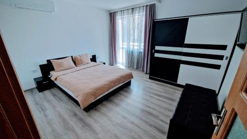 a bedroom with a bed and a flat screen tv at Water House in Shumen