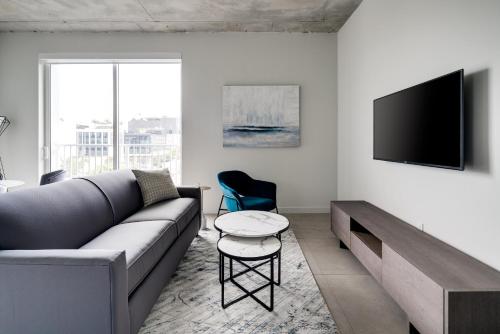 a living room with a couch and a tv at Kasa Wynwood Miami in Miami