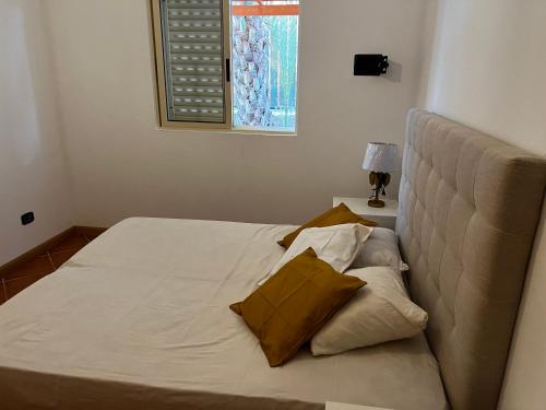 a bed with two pillows on it in a bedroom at Beira Mar AB2 in Santa Maria