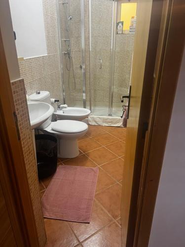a bathroom with two toilets and a shower at Beira Mar AB2 in Santa Maria