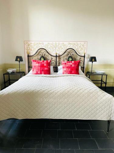 a bedroom with a large bed with red pillows at Gästehaus Schönitz in Meißen