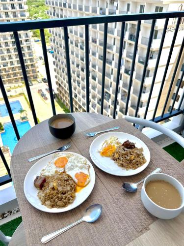 a table with two plates of food and a cup of coffee at Enchanté Studios in Suba