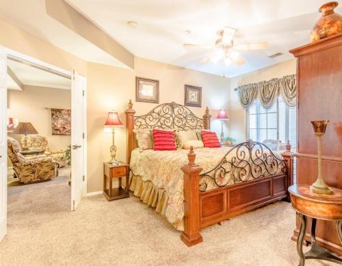 a bedroom with a large bed with red pillows at Branson Condo at Thousand Hills Walkin with Elevator Golf Front near 76 Strip in Branson