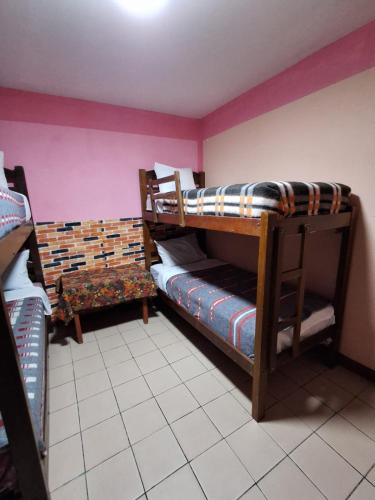 a room with two bunk beds in a room at Backpackers Oruro B&B in Oruro
