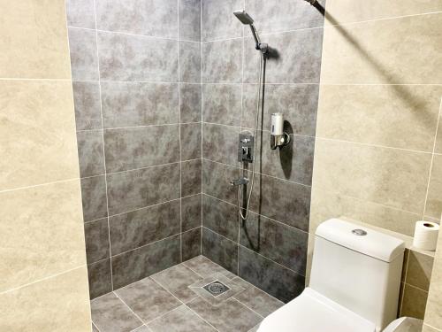 a bathroom with a shower with a toilet at Deco Home @ Aru Suites in Kota Kinabalu