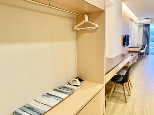 a room with a bed and a desk at Deco Home @ Aru Suites in Kota Kinabalu