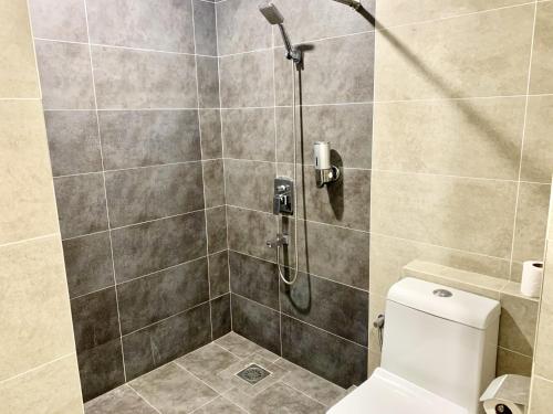 a bathroom with a shower with a toilet at Deco Home @ Aru Suites in Kota Kinabalu