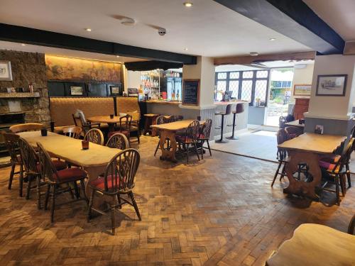un restaurante con mesas y sillas y un bar en East Dart Inn, en Yelverton