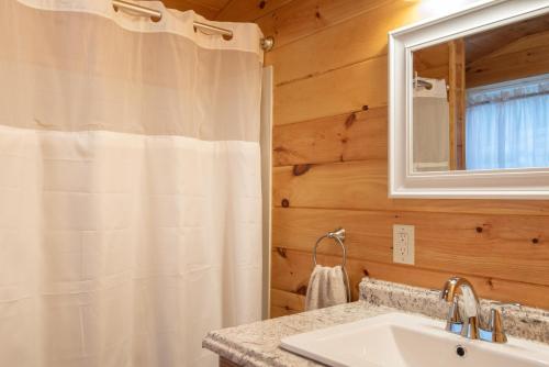 a bathroom with a shower curtain and a sink at Fisher Mountain Retreat 