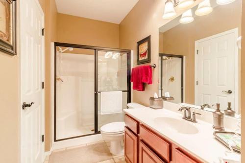 a bathroom with a shower and a toilet and a sink at Branson Condo at Thousand Hills Walkin with Elevator Golf Front near 76 Strip in Branson