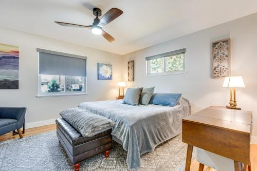 a bedroom with a bed and a couch at Modern Wheat Ridge Home with Private Hot Tub and Sauna in Wheat Ridge