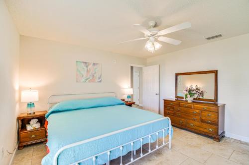 a bedroom with a blue bed and a ceiling fan at Family-Friendly Foley Getaway with Fenced Yard! in Foley