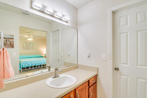 a bathroom with a sink and a mirror at Family-Friendly Foley Getaway with Fenced Yard! in Foley