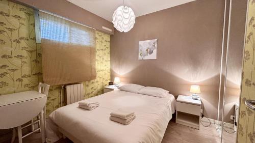 une chambre avec un lit avec deux serviettes dessus dans l'établissement Appartement pour 4 personnes proche mer, au Crotoy