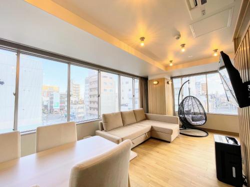 a living room with a couch and a table at Hotel Yuzuki in Takamatsu