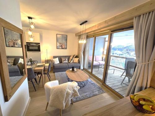 a living room with a couch and a table at Résidence Phoenix C by Leavetown Vacations in L'Alpe-d'Huez