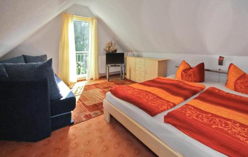 a bedroom with a large bed and a couch at Gorgeous Apartment In Waren mritz With Wifi in Warenshof