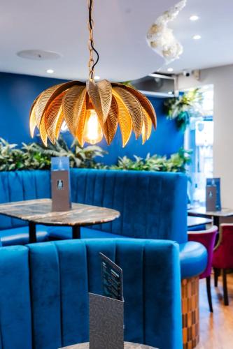 a dining room with a blue couch and a table at Harrys lounge in Whitby