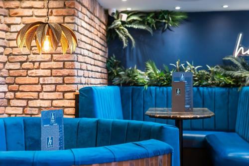 a row of blue couches in a room with plants at Harrys lounge in Whitby